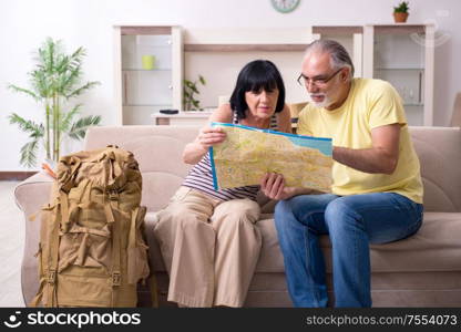 The old couple preparing for vacation travel. Old couple preparing for vacation travel