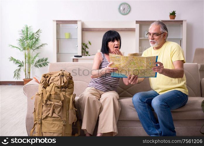 The old couple preparing for vacation travel. Old couple preparing for vacation travel