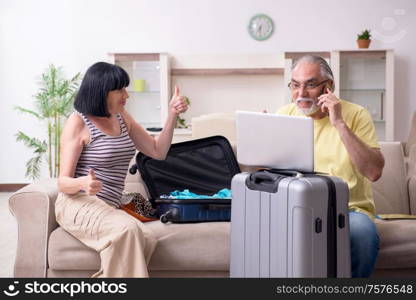 The old couple preparing for vacation travel. Old couple preparing for vacation travel