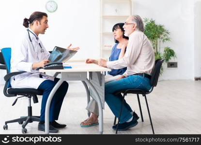 The old couple visiting young male doctor. Old couple visiting young male doctor