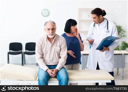The old couple visiting young male doctor. Old couple visiting young male doctor