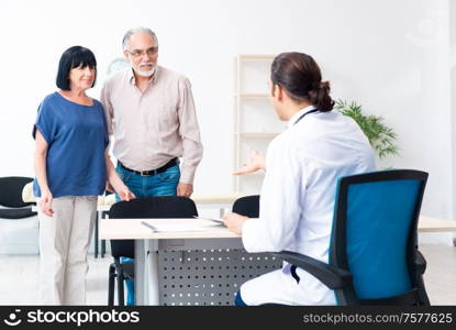 The old couple visiting young male doctor. Old couple visiting young male doctor