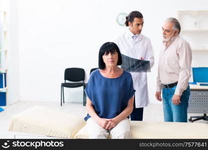 The old couple visiting young male doctor. Old couple visiting young male doctor