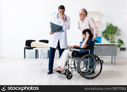 The old couple visiting young male doctor. Old couple visiting young male doctor