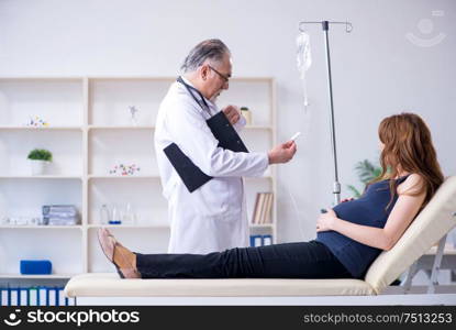 The old doctor examining young woman. Old doctor examining young woman