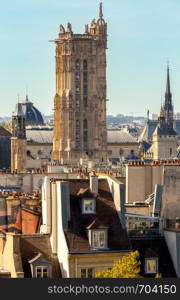 The old famous tower of Saint-Jacques on the background of city roofs. Paris, France.. Paris. Scenic aerial view of the city and the tower of Saint-Jacques.
