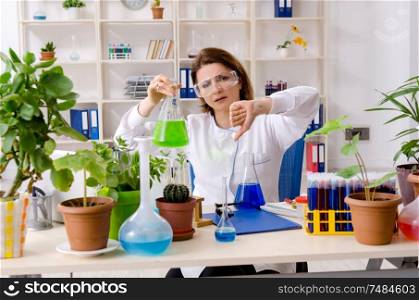 The old female biotechnology chemist working in the lab. Old female biotechnology chemist working in the lab