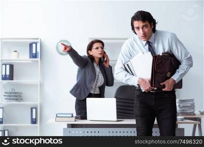 The old female boss and young male employee in the office. Old female boss and young male employee in the office