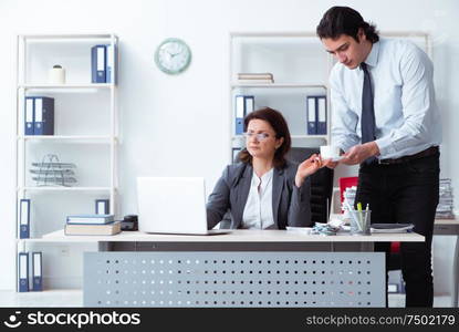 The old female boss and young male employee in the office. Old female boss and young male employee in the office