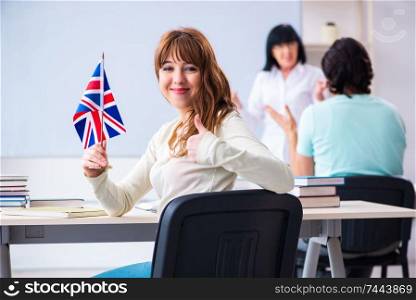 The old female english teacher and students in the classroom . Old female english teacher and students in the classroom 