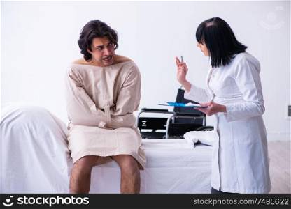 The old female psychiatrist visiting young male patient . Old female psychiatrist visiting young male patient