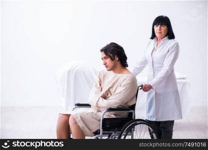 The old female psychiatrist visiting young male patient. Old female psychiatrist visiting young male patient