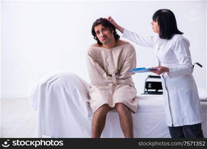 The old female psychiatrist visiting young male patient. Old female psychiatrist visiting young male patient