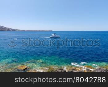 The old fishing harbor in the village Oia.. Old Port in the village Oia on Santorini island in the Aegean Sea. Greece.