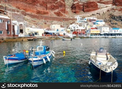 The old fishing harbor in the village Oia.. Old Port in the village Oia on Santorini island in the Aegean Sea. Greece.