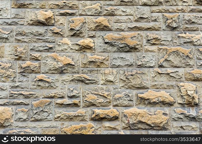 The old gray brick wall for design backgrounds
