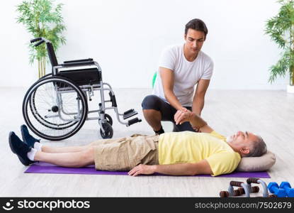 The old injured man doing exercises indoors. Old injured man doing exercises indoors