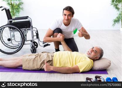 The old injured man doing exercises indoors. Old injured man doing exercises indoors