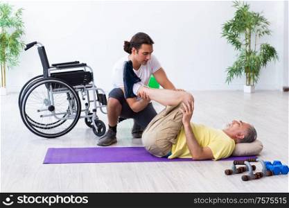 The old injured man doing exercises indoors. Old injured man doing exercises indoors