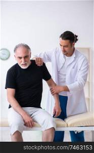 The old injured man visiting young doctor . Old injured man visiting young doctor 