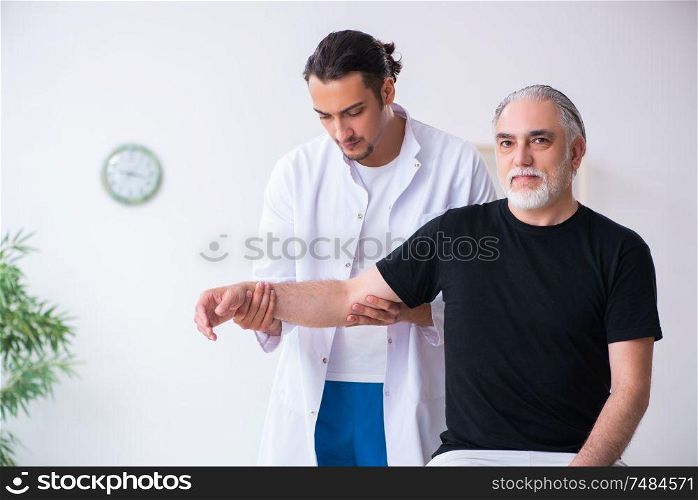The old injured man visiting young doctor . Old injured man visiting young doctor