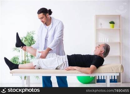 The old injured man visiting young doctor. Old injured man visiting young doctor