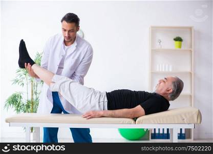 The old injured man visiting young doctor. Old injured man visiting young doctor
