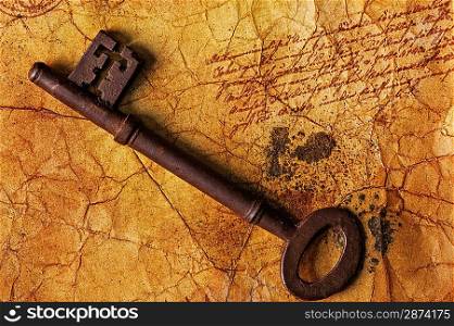 The old key on the textured paper