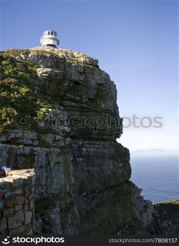 The old lighthouse at Cape Point, South Africa is a beacon that helps ships navigate around the Cape of Good Hope between the Indian and Atlantic Oceans.