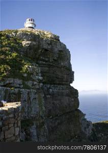 The old lighthouse at Cape Point, South Africa is a beacon that helps ships navigate around the Cape of Good Hope between the Indian and Atlantic Oceans.