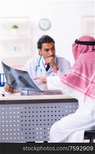 The old male arab visiting young male doctor. Old male arab visiting young male doctor