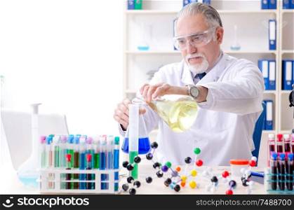 The old male chemist working in the lab. Old male chemist working in the lab