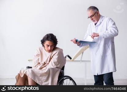 The old male doctor psychiatrist and patient in wheel-chair  . Old male doctor psychiatrist and patient in wheel-chair  