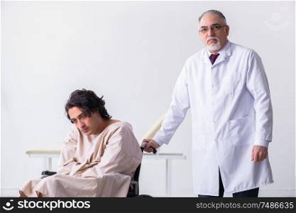 The old male doctor psychiatrist and patient in wheel-chair . Old male doctor psychiatrist and patient in wheel-chair