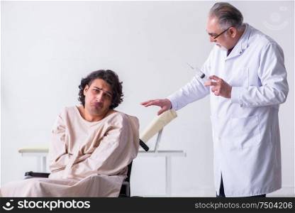 The old male doctor psychiatrist and patient in wheel-chair. Old male doctor psychiatrist and patient in wheel-chair