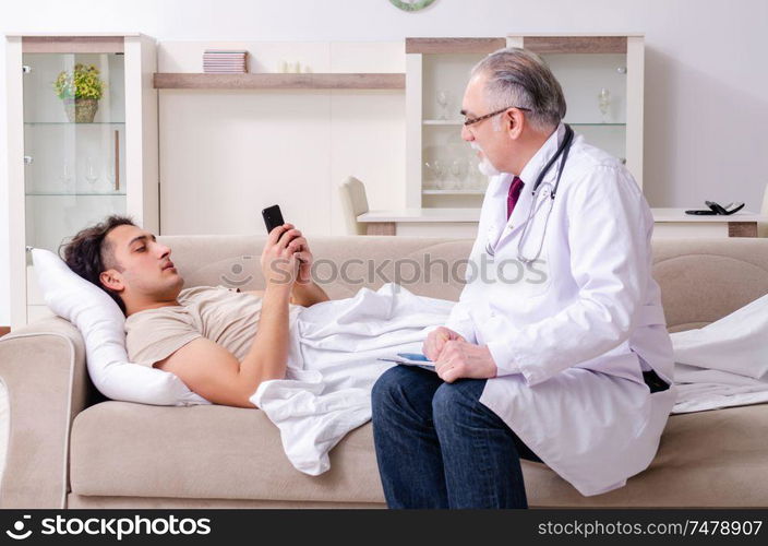 The old male doctor visiting young male patient . Old male doctor visiting young male patient