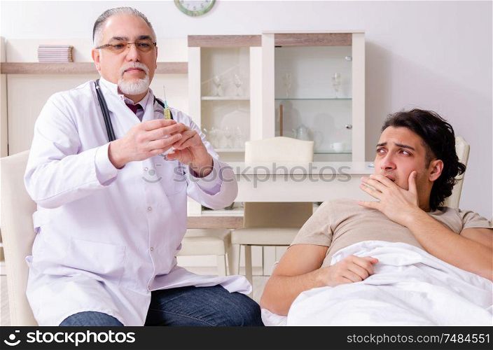The old male doctor visiting young male patient . Old male doctor visiting young male patient