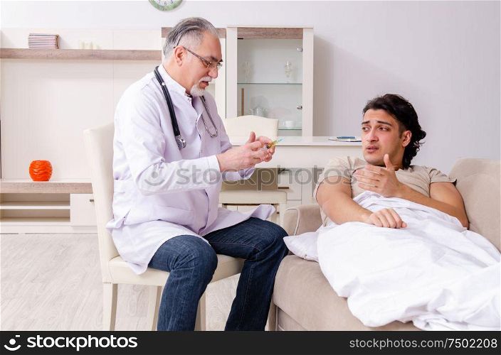 The old male doctor visiting young male patient. Old male doctor visiting young male patient