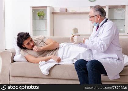 The old male doctor visiting young male patient. Old male doctor visiting young male patient