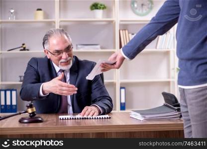 The old male lawyer in corruption concept . Old male lawyer in corruption concept 