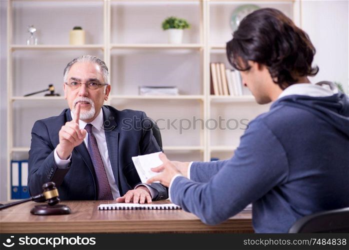 The old male lawyer in corruption concept. Old male lawyer in corruption concept