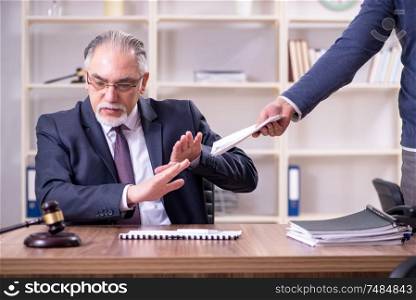 The old male lawyer in corruption concept. Old male lawyer in corruption concept