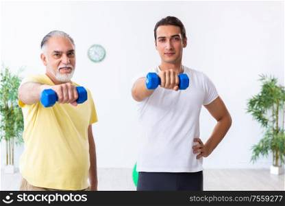 The old man doing exercises indoors. Old man doing exercises indoors
