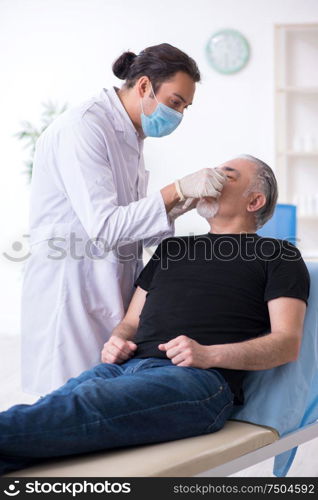 The old man visiting young doctor for plastic surgery. Old man visiting young doctor for plastic surgery