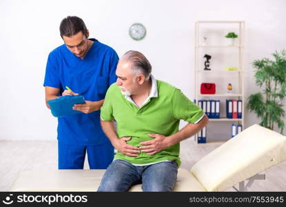 The old man visiting young male doctor gastroenterologist. Old man visiting young male doctor gastroenterologist