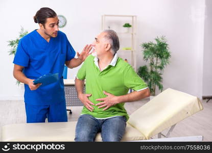 The old man visiting young male doctor gastroenterologist. Old man visiting young male doctor gastroenterologist