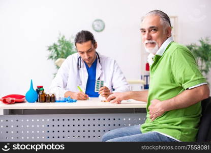 The old man visiting young male doctor gastroenterologist. Old man visiting young male doctor gastroenterologist