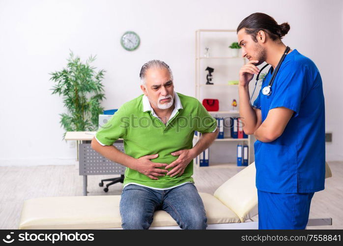 The old man visiting young male doctor gastroenterologist. Old man visiting young male doctor gastroenterologist