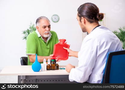 The old man visiting young male doctor gastroenterologist. Old man visiting young male doctor gastroenterologist