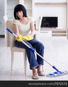 The old mature woman tired after house chores. Old mature woman tired ...